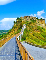Fototapeta na wymiar View of Civita village located on a hill and connected with Bagnoregio town by a bridge in central Italy.
