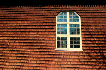 A detail of the traditional wooden house in scandinavia with its red colored planks. The color is called "falun red". 
