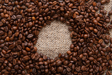 Coffee beans and sackcloth background, place for your brand