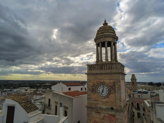 Aerial Shot of the Clocktower that is the Symbol of the City of Noci, Near Bari, in the South of Italy, on Partially Cloudy Sky Background at Sunset