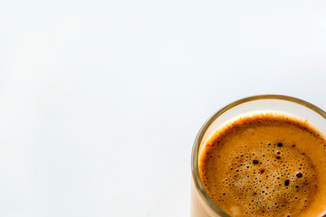 A cup of coffee on the window. A cup of black coffee. Coffee with milk. A small cup of coffee