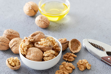Fresh, delicious walnuts, Walnut oil and nutcracker on a stone table