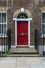 Little red door on a classic London terrace house.