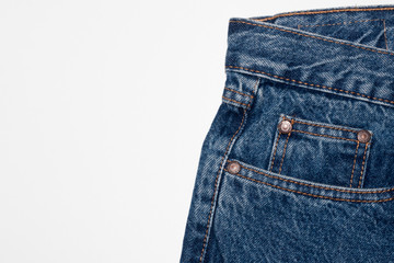 Classic blue jeans front pockets. rough denim texture. jeans on a pure white background. free space for text