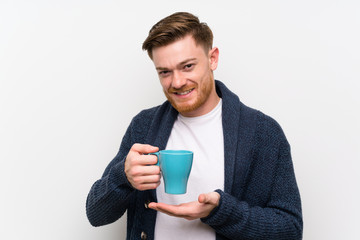 Redhead man holding a cup of coffee