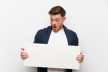 Redhead man holding an empty placard