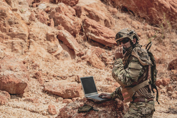 Soldiers of special forces on wars at the desert,Thailand people,Army soldier use laptop for see...