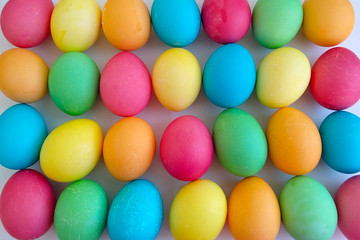 Colorful Easter eggs background. Yellow, green, blue painted eggs on Easter top view.