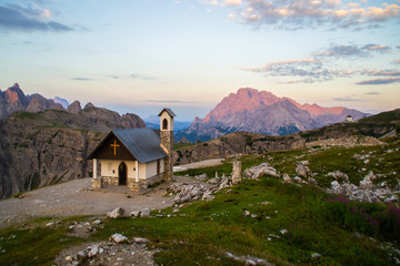 Beautiful panorama view of Cappella degli Alpini chapel in Tre Cime di lavaredo National Park. Idyllic sunrise landscape scene in Dolomites, Tirol Alps, Italy