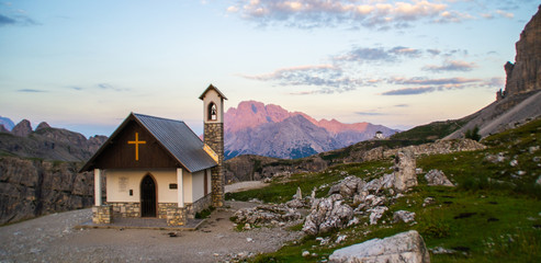 Beautiful panorama view of Cappella degli Alpini chapel in Tre Cime di lavaredo National Park. Idyllic sunrise landscape scene in Dolomites, Tirol Alps, Italy