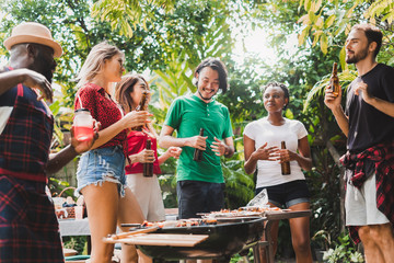 Group of diversity people having barbecue/barbeque party at home, cooking grilled meat/beef for lunch, happy friends party lifestyle concept