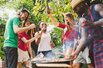 Group of diversity people having barbecue/barbeque party at home, cooking grilled meat/beef for lunch, happy friends party lifestyle concept