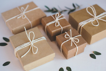 Craft gift boxes on white wooden background.