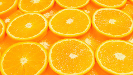 Slices of oranges as a background, top view.