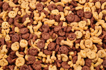  Chocolate flakes in the form of skulls and bones background. Top view.