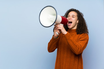 Dominican woman with curly hair shouting through a megaphone