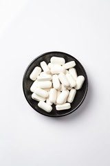 Fototapeta na wymiar GABA (GAMMA-AMINOBUTYRIC ACID) Tablets. Concept for a healthy dietary supplementation. White background. Top view. Copy space. 
