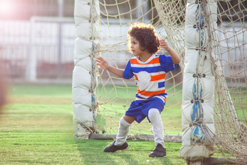 Little goalkeeper used hands for catches the ball in match game