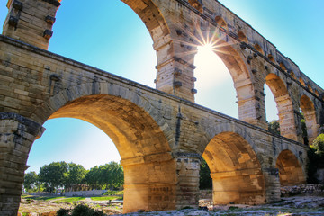 Aqueduct Pont du Gard with sunburst, southern France