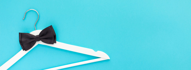 White wooden hangers on blue background