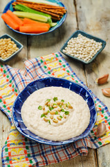 White bean hummus on a wood background