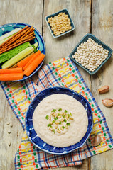 White bean hummus on a wood background