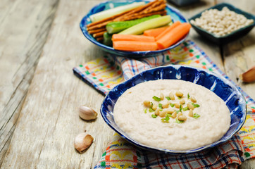 White bean hummus on a wood background