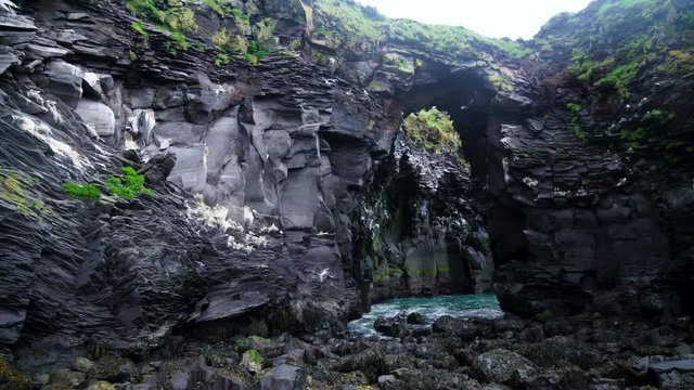 Rocky coastline landscape in Hellnar, Iceland. Hellnar was among the largest fishing villages beneath the Snaefellsjokull ice cap in West Iceland.