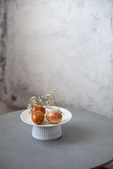 Easter Eggs In Basket, Naturally Dyed with Onion Skins, Flowers  and Herbs on marble background with copy space