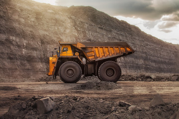 mining truck in a coal mine at sunset