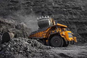 Fotobehang Vrachtwagen loader bucket on loading coal into a mining truck  © Евгений Мирошниченко