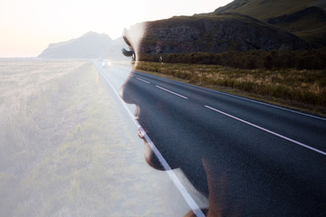 Profile of a young beautiful woman and the road, double exposure. Goal setting and dreams