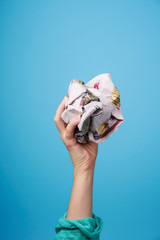 hand with crumpled newspaper.