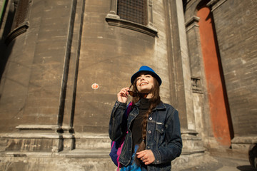 Fototapeta na wymiar Young woman standing near the church in old city Lviv. Ukraine
