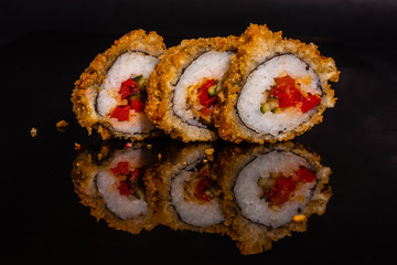 Fresh and tasty sushi on dark background. It can be used as a background