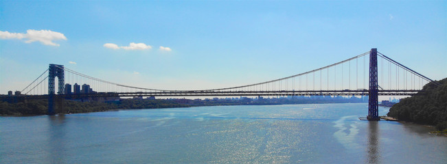 Aerial view of George Washington Bridge in Fort Lee, NJ. George Washington Bridge is a suspension bridge spanning the Hudson River connecting NJ to Manhattan, NY. Panorama of GWB during summer