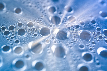 Water drops macro shot. Sun rays reflected from  drop of water