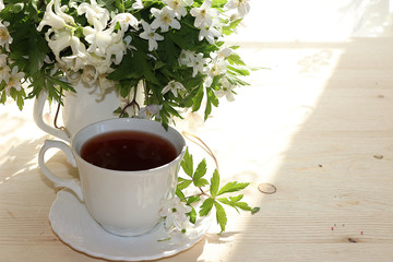 A cup of tea on a sunny table, a bouquet of spring flowers for mood, diet food and a healthy lifestyle in the village, a beautiful morning in the village, a very tasty dessert