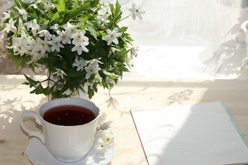 A cup of tea on a sunny table, a bouquet of spring flowers for mood, diet food and a healthy lifestyle in the village, a beautiful morning in the village, a very tasty dessert