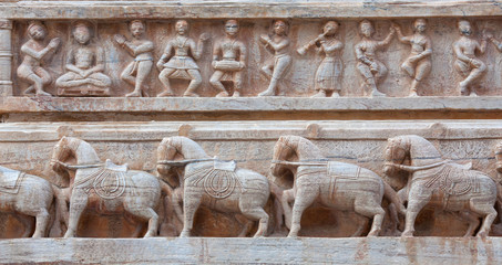 Fototapeta na wymiar Bas-relief with dancing Apsaras, horses and musicians at famous ancient Jagdish Temple in Udaipur, Rajasthan, India