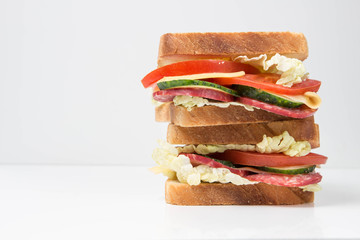 big sandwich with fresh vegetables on white background