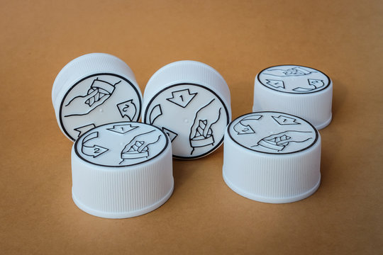 Plastic child resistant bottle caps on a brown background