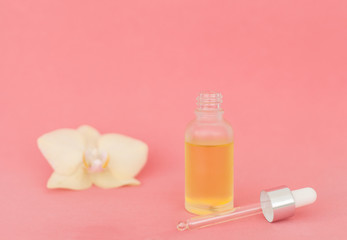 Homeopathic oils, dietary supplements for intestinal health, skin care. Natural cosmetics, oils for skin care on a pink background with flower