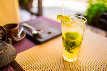 Mojito concept. Alcoholic drink put on table in restaurant close up