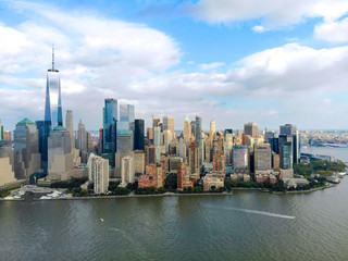 Fototapeta premium Stunning aerial view of Manhattan Skyline, with World Trade Center, New York, USA. Panoramic skyline with skyscrapers and financial district and Hudson river, New York, USA