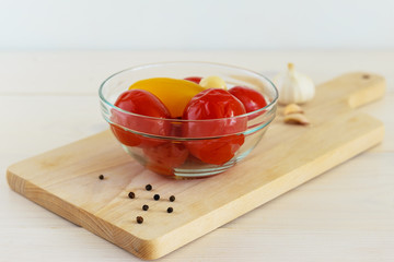 Marinated tomatoes in a glass bowl on the table. Fermented food close up