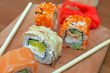 Still life with sushi rolls soy sauce, napkins and chopsticks