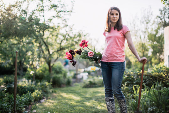 Young beautiful woman getting ready to plant tulips
