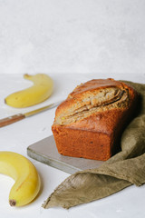Banana bread with bananas on a light background with copy space.