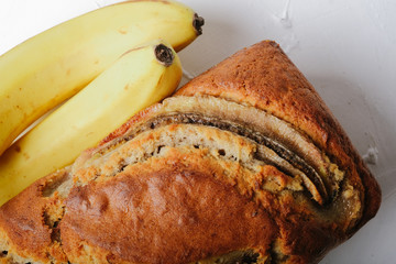 Banana bread with bananas on a light background with copy space.